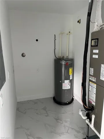 Utility room featuring electric water heater