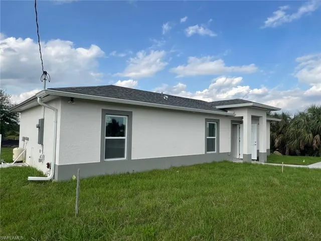 View of property exterior featuring a yard