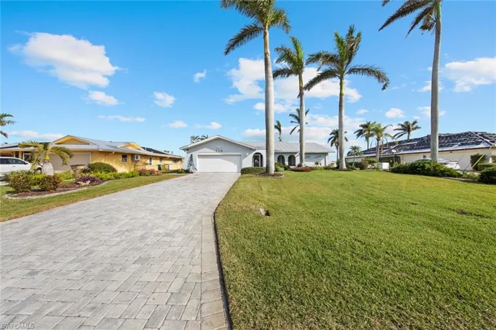 Single story home featuring a front yard and a garage