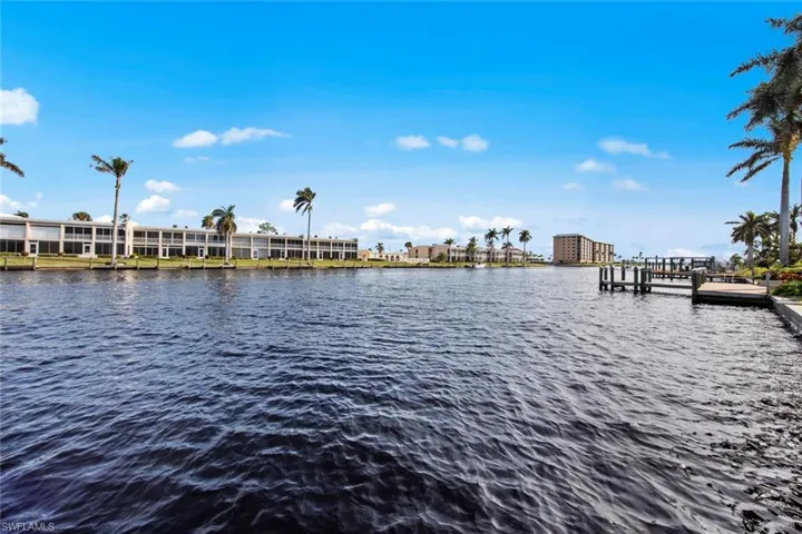 Property view of water with a dock