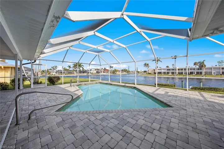 View of pool featuring a water view, a patio area, and a lanai