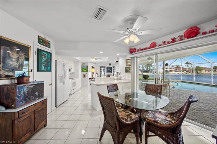 Tiled dining area featuring ceiling fan