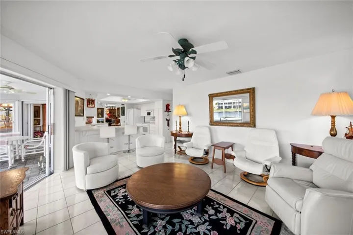 Tiled living room featuring ceiling fan