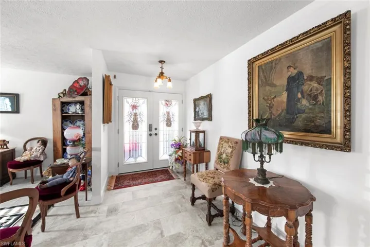 Entrance foyer with french doors and a textured ceiling