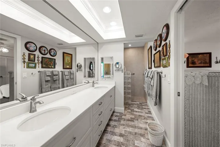 Bathroom featuring a tile shower and vanity