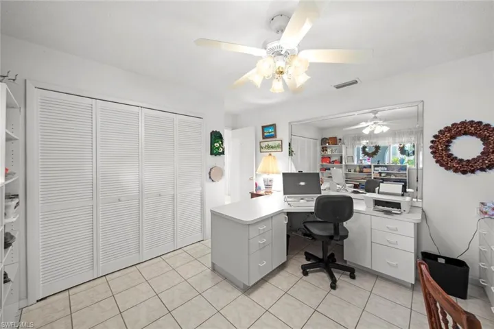 Office area featuring ceiling fan and light tile patterned flooring
