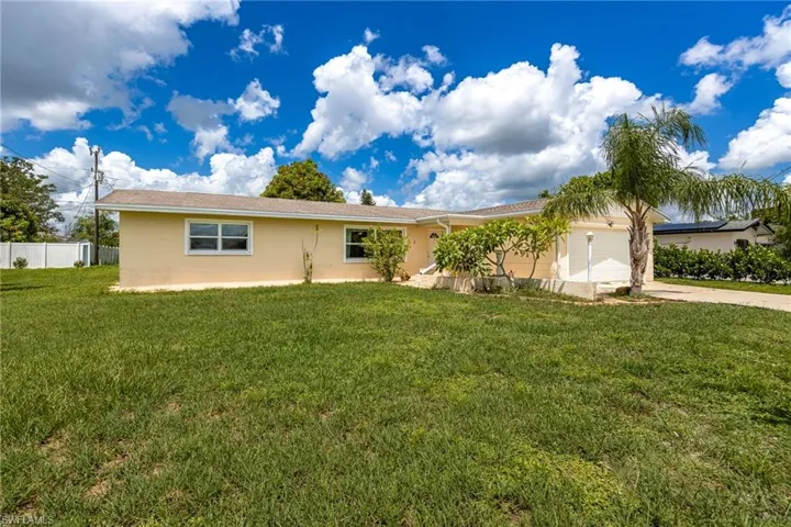 Ranch-style home with an attached garage and concrete driveway