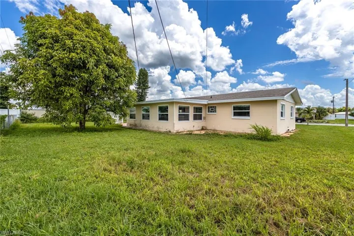 Back of property with a yard