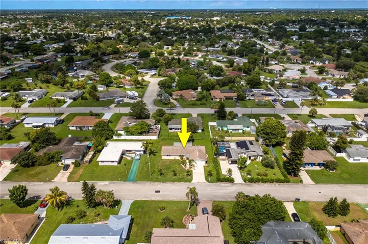 Aerial view of property's location with nearby suburban area