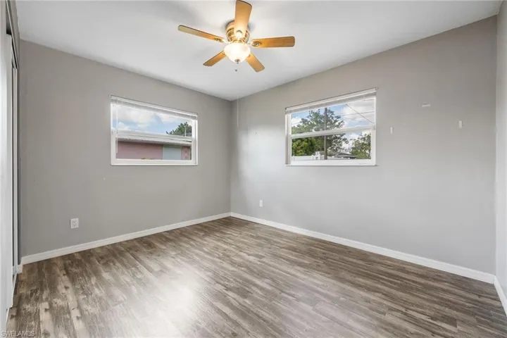 Unfurnished room with wood finished floors and ceiling fan