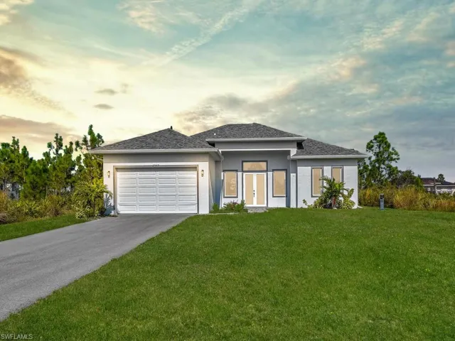Prairie-style house with a 2 car garage and a yard