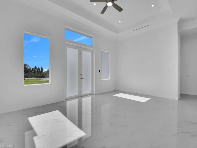 Entrance , ceiling fan, a raised ceiling, and french doors