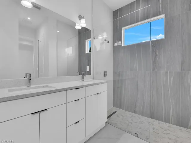 Bathroom featuring double vanity and walk in shower