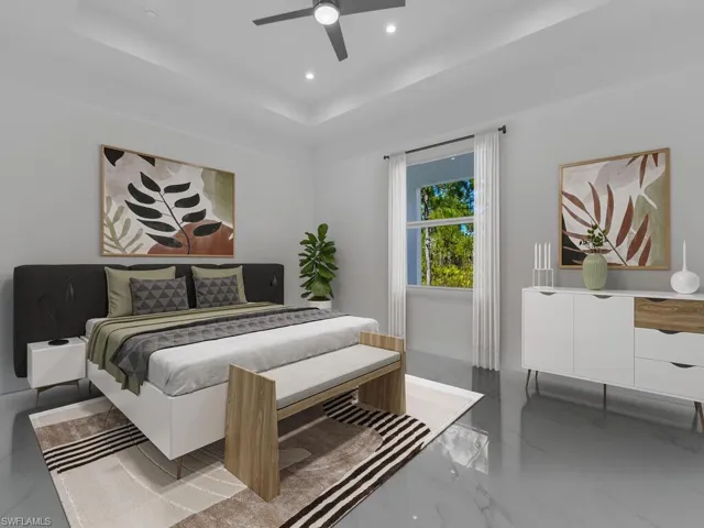 Primary Bedroom featuring a tray ceiling and ceiling fan. Furnitures are not included