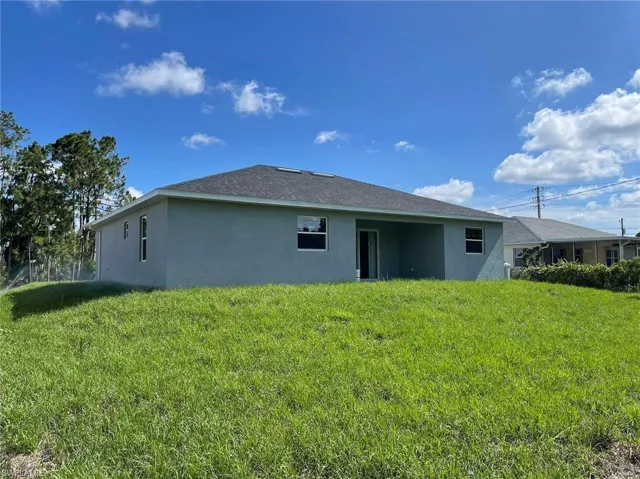 Back of house with a lawn