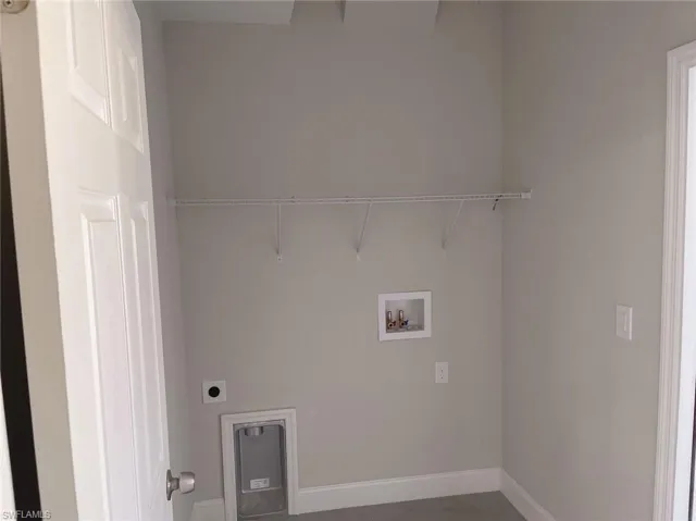 Washroom featuring hookup for a washing machine and electric dryer hookup