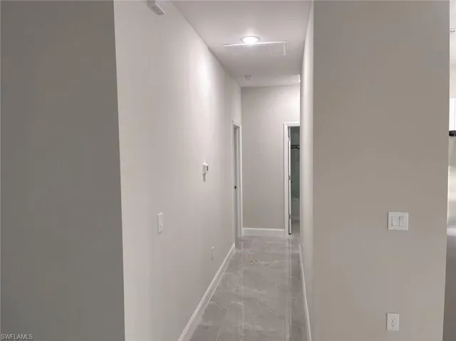 Hall featuring light tile patterned floors