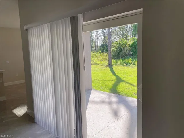 Doorway to outside featuring concrete flooring