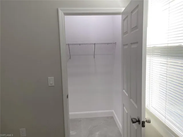 Spacious closet featuring tile patterned flooring