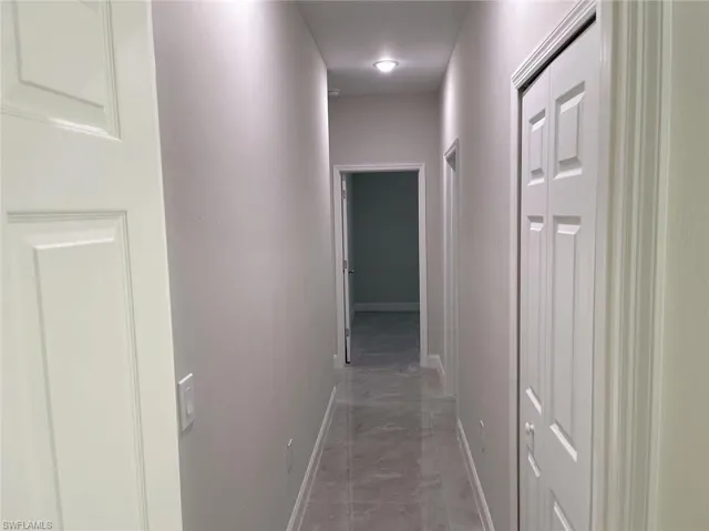 Hallway featuring tile patterned flooring