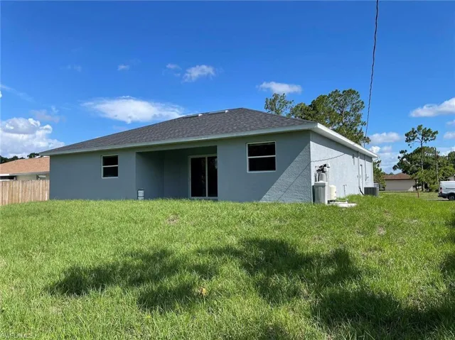 Rear view of property featuring a yard
