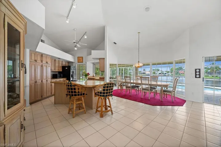 Kitchen, dining room and family room. Tall ceilings and wall to wall view of the pool and the canals.