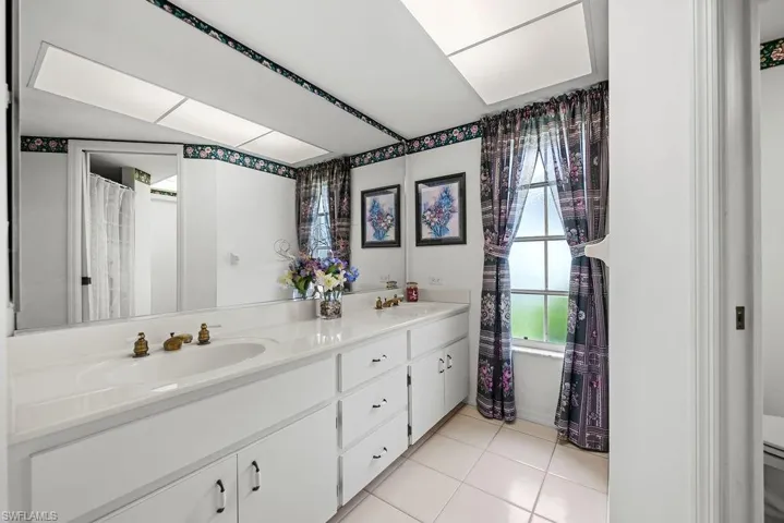 Main bathroom with shower and dual sinks