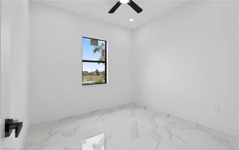 Bright interior space featuring white walls and white baseboards