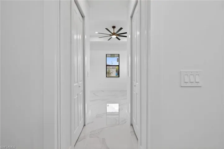 Hallway with white walls and a light switch panel