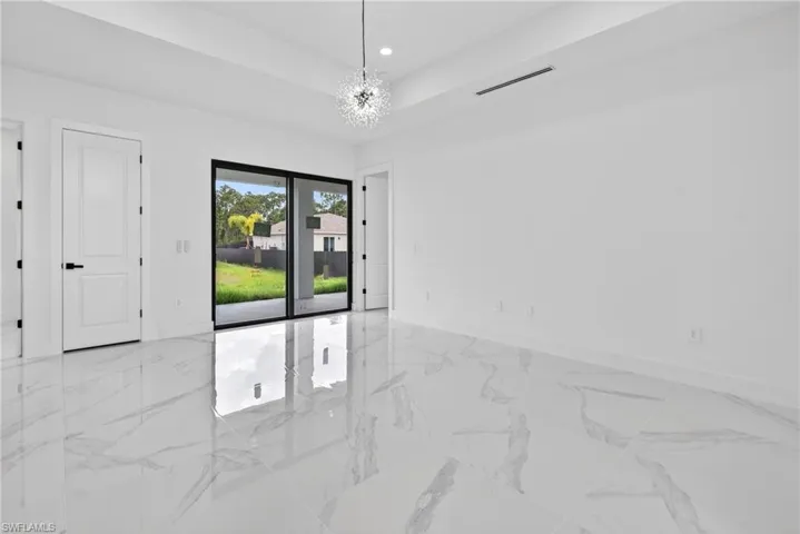 Spacious room with large format polished white tile flooring, offering a modern aesthetic