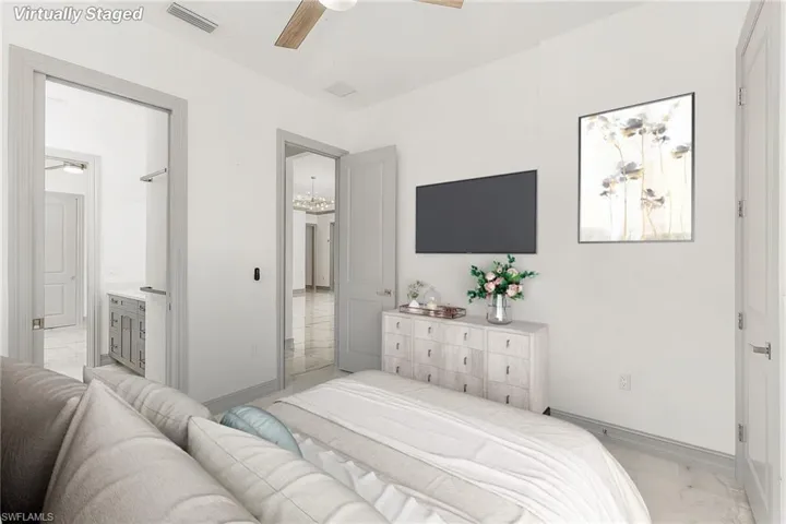 Bedroom with ceiling fan, connected bathroom, and light tile patterned floors