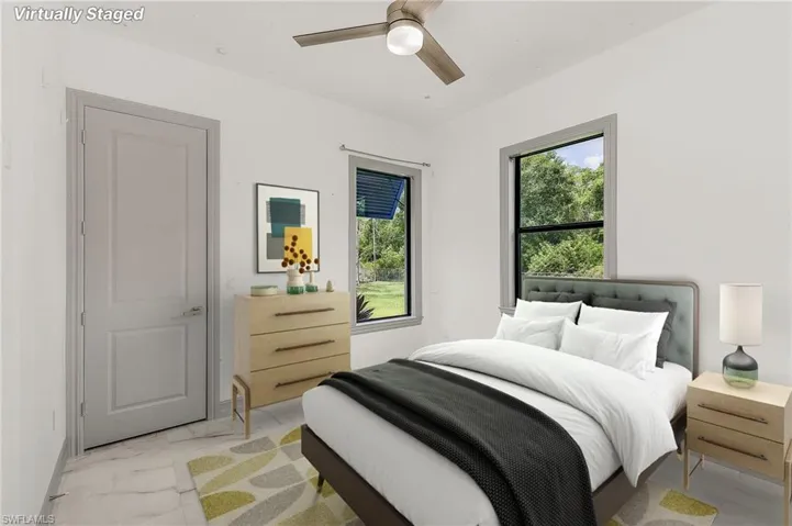 Tiled bedroom with ceiling fan and multiple windows