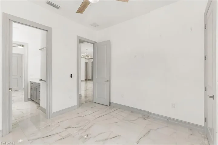 Unfurnished room featuring ceiling fan and light tile flooring