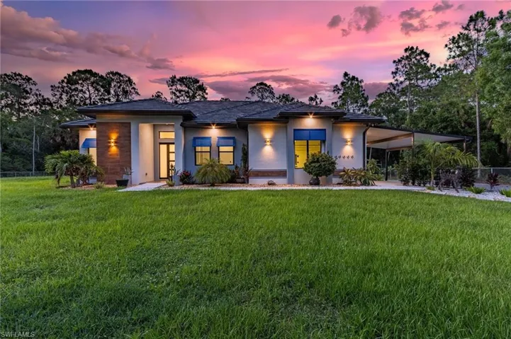 Prairie-style home with a lawn
