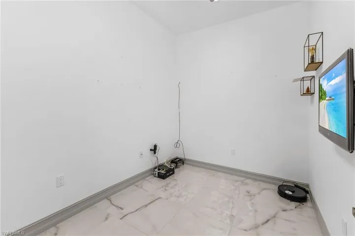 Laundry area with tile flooring