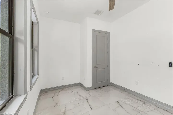 Unfurnished room featuring light tile flooring