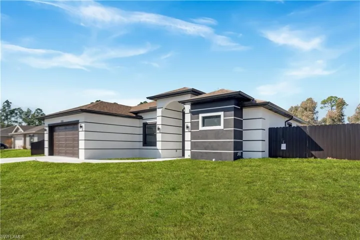 Prairie-style house featuring concrete driveway and an attached garage
