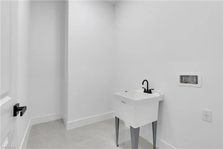 Laundry area with washer hookup and baseboards