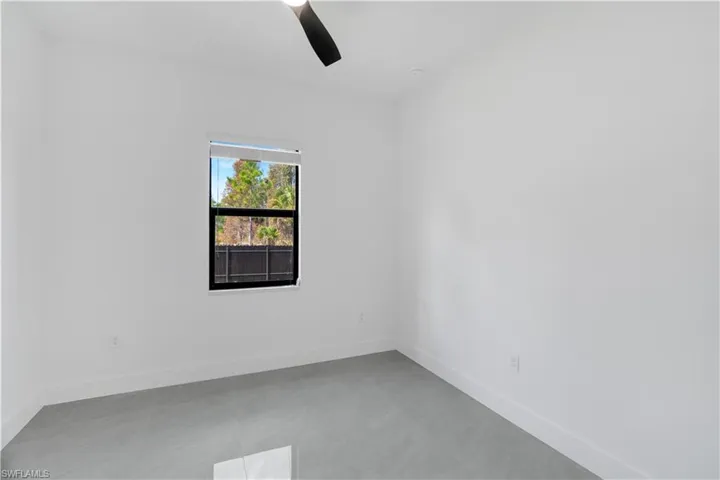 Empty room with baseboards and ceiling fan