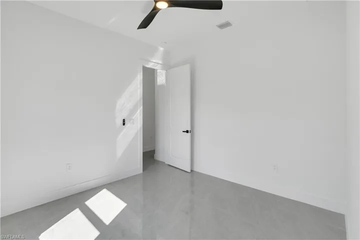 Spare room featuring baseboards and a ceiling fan