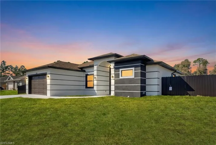 Prairie-style home with a garage and concrete driveway