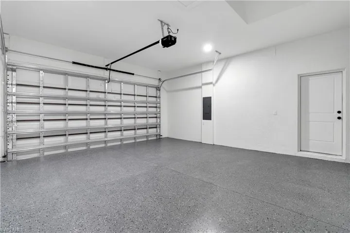 Garage with electric panel and a garage door opener