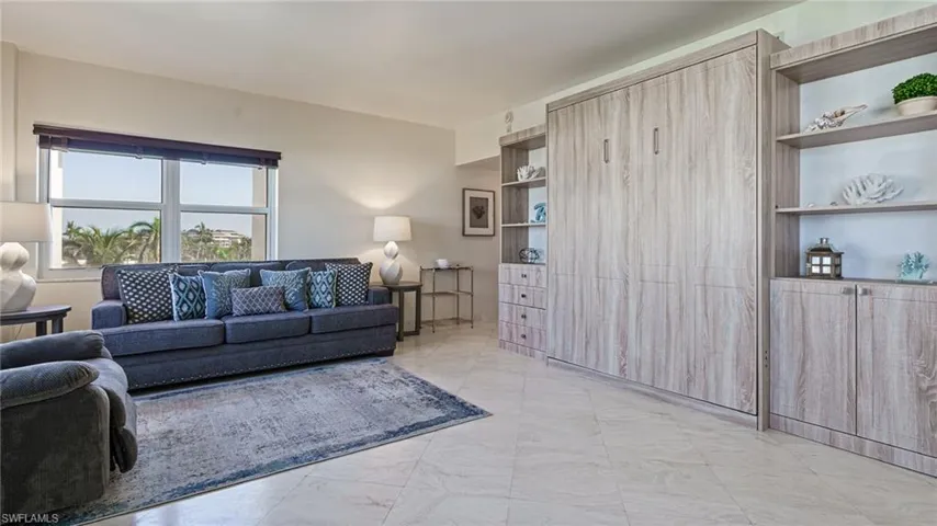 Tiled living room featuring built in features