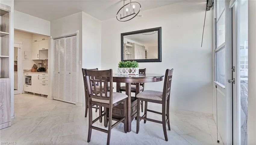 Dining space featuring a notable chandelier and light tile patterned flooring