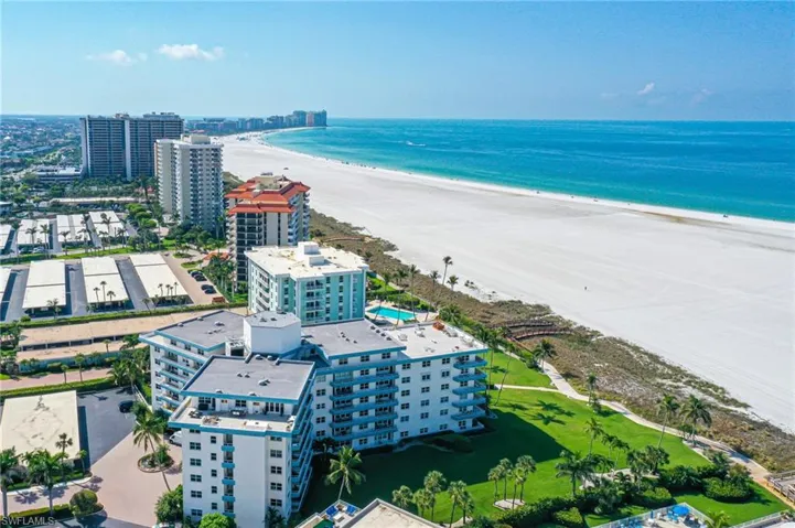 Aerial view featuring a water view and a beach view