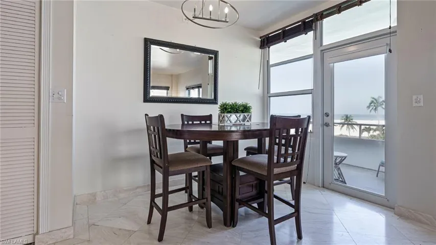 Dining space featuring a notable chandelier and light tile patterned flooring