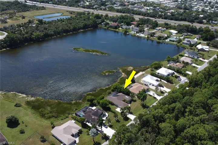Aerial view of the property, showcasing its direct lakefront access and surrounding green spaces