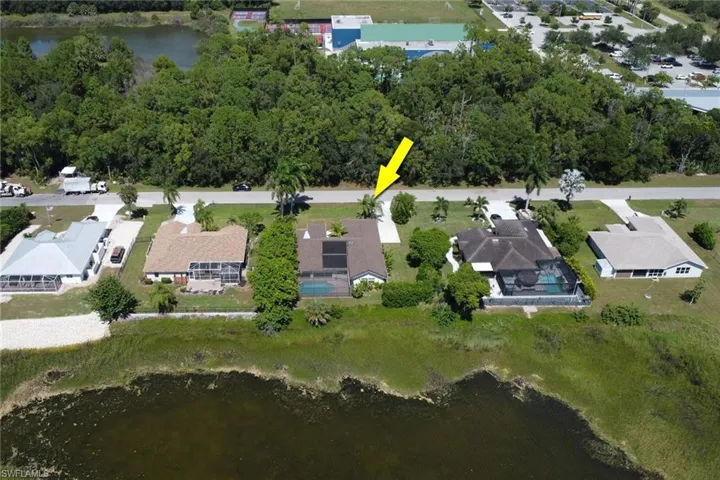 The property features a private swimming pool with a screened enclosure