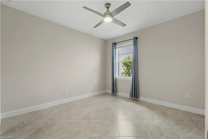 Recessed lighting, ceiling fan with integrated light, window with natural light, tile flooring, and neutral wall tones
