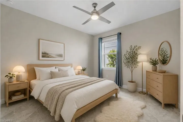 Spacious room featuring ceiling fan with integrated lighting, window with blue drapes, and light-toned flooring